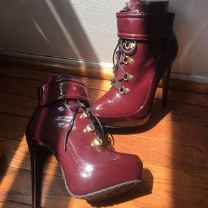 Cool and shiny burgundy heeled boots. -